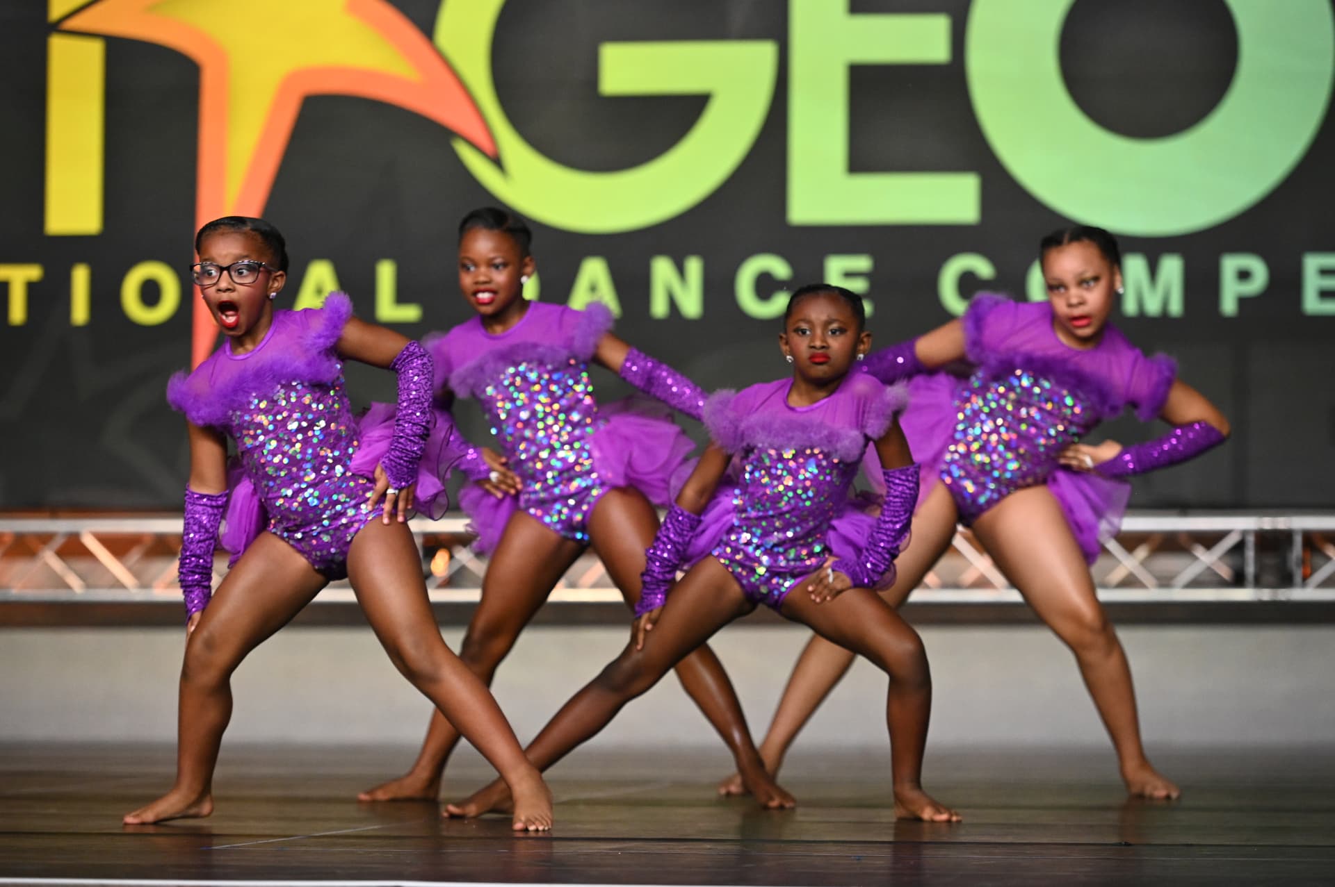 Dance ELITE dancers performing in purple competition costumes